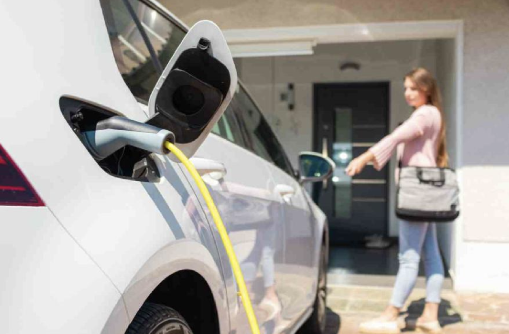 A woman charging EV at home